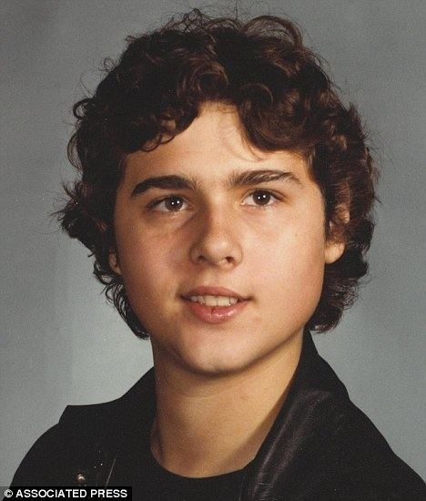 A teenage David Reimer smiling and wearing a black jacket and inner shirt.