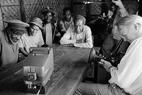 A group of men watching the news in a movie scene from Dead Birds, a 1963 American documentary film.