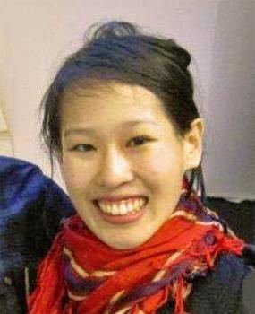 Elisa Lam smiling and wearing a black blouse with a red scarf around her neck