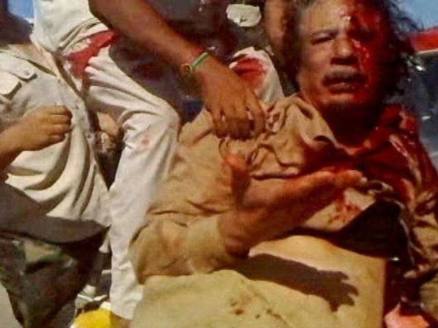 Muammar Gaddafi with blood on his face after the attack.