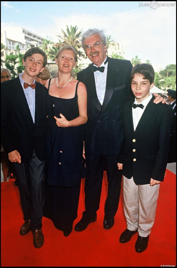 Sophie Toscan du Plantier wearing a black dress while Daniel Toscan du Plantier wearing a black suit and a bowtie, with their sons Maxime and Carlo both wearing a black suit and a bow tie.