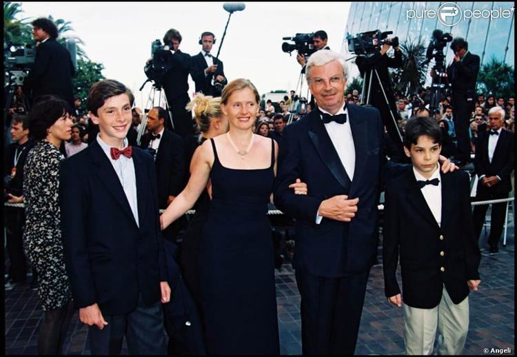 Sophie Toscan du Plantier wearing a black dress while Daniel Toscan du Plantier wearing a black suit and a bowtie, with their sons Maxime and Carlo both wearing a black suit and a bow tie.
