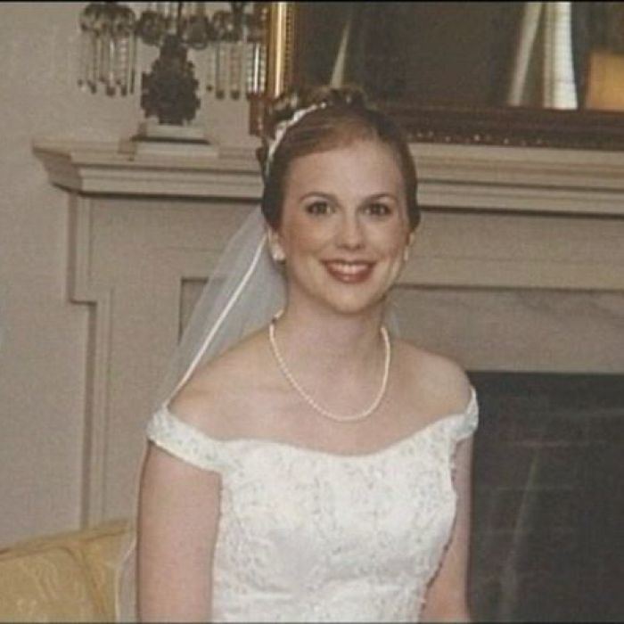 Tina Watson smiling while wearing her wedding gown