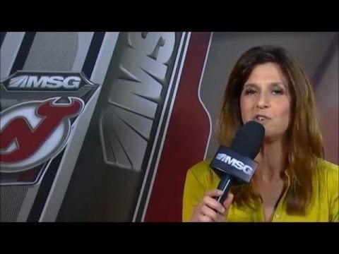 Deb Placey delivering a news report while wearing a yellow blouse