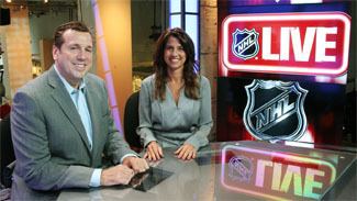 Deb Placey smiling with the man beside her at the studio of NHL Live while she is wearing a gray long sleeve dress