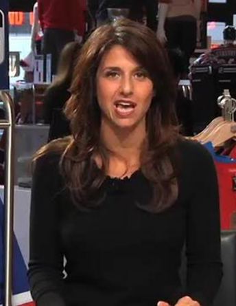 Deb Placey delivering a news report while wearing a black long sleeve blouse