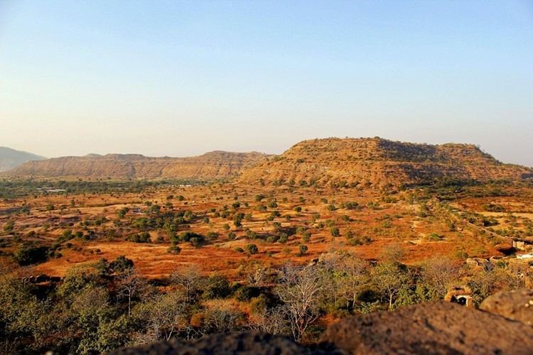 The Deccan Plateau in Southern India features mountains, trees, and shrubs.