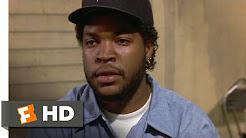 Ice Cube as Doughboy in the 1991 film Boyz n the Hood wearing a black cap and a blue polo shirt.