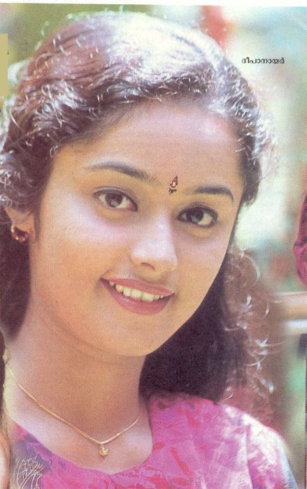 Deepa Nair wearing a pink shirt, a necklace, and earrings