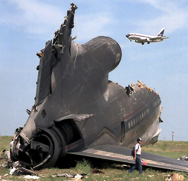 Delta Air Lines Flight 191 The crash of Delta Air Lines Flight. A man walking beside the crashed flight.