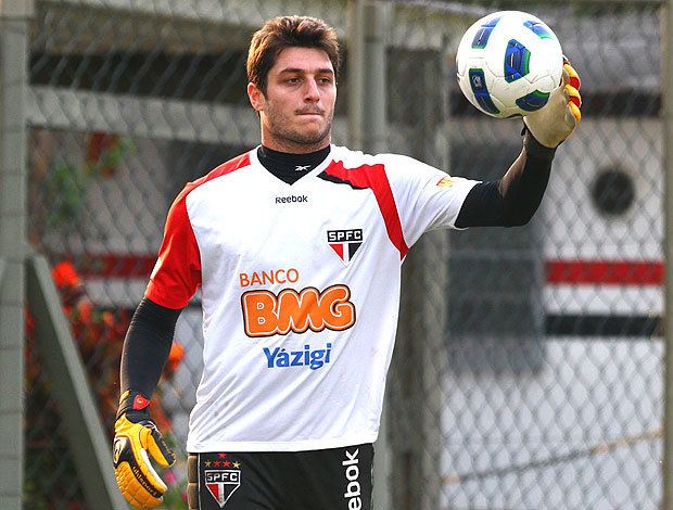 Denis Cesar holding a ball while wearing white and orange printed shirt