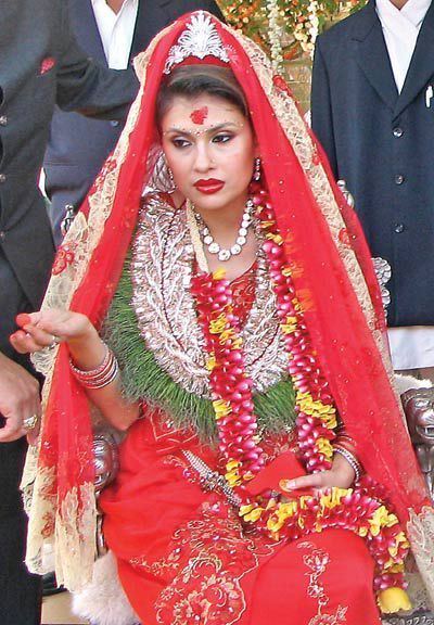 Devyani Rana wearing a red gown during their wedding