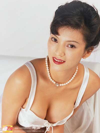 Diana Pang smiling and wearing a white dress and necklace.