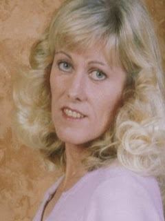 Diane Downs in curly blonde hair while wearing pink blouse