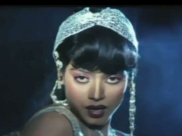 Disco Shanti with a seductive look while wearing a white headdress