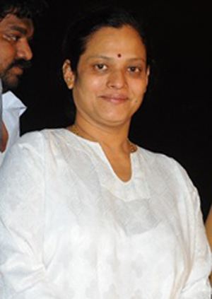 Disco Shanti smiling while wearing a white blouse