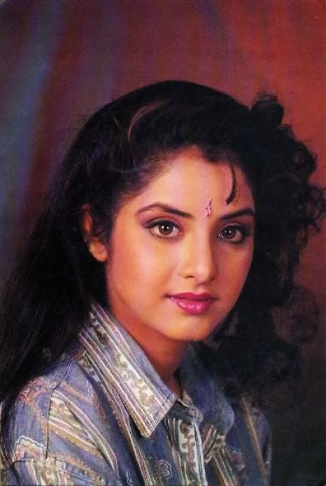 Divya Bharti with curly hair, wearing a blue polo shirt.