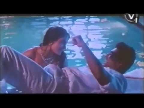 A scene from Diya Aur Toofan featuring Mithun Chakraborty as Amar and Madhoo as Asha in the pool.