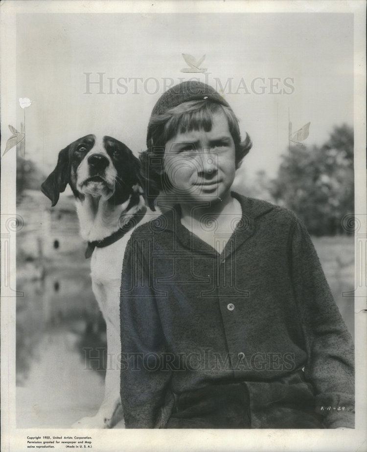 Donald MacDonald wearing cap and long sleeves and a dog beside him