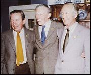 Donald Sinclair, James Alfred Wight, and Brian Sinclair standing and smiling together while wearing a suit