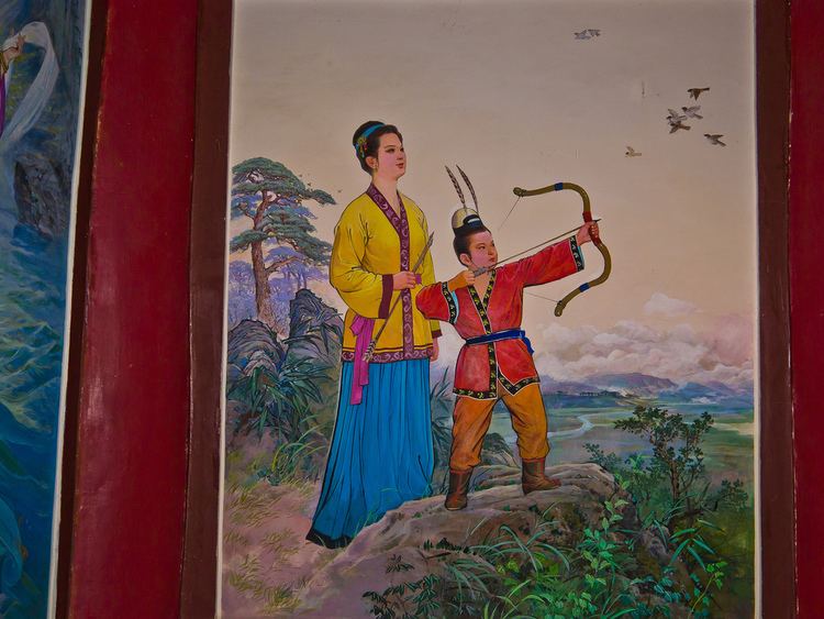 A painting of Dongmyeong of Goguryeo practicing archery with his bow and arrow with a woman behind him