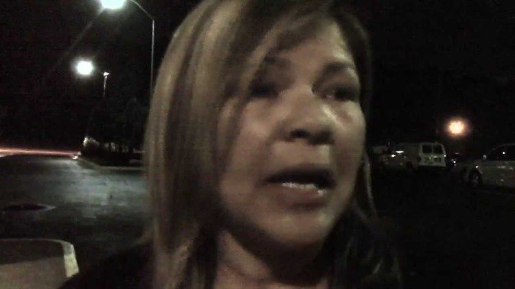 Donna Wilkes being interviewed in a parking lot at night.