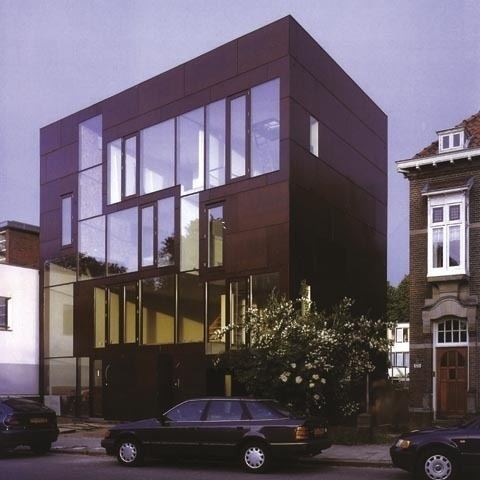 A Double House in an urban neighborhood with cars visible.