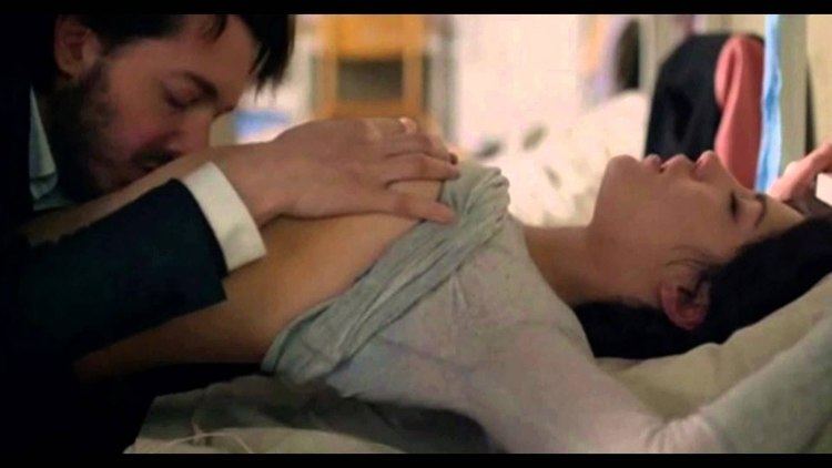 Guillaume Gallienne holding Adèle Exarchopoulos' breast and kissing her belly in a movie scene from Down by Love (2016 drama film)