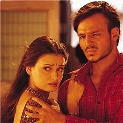 Dia Mirza and Vivek Oberoi with angry faces while looking at someone in a scene from the 2003 Indian Hindi-language action film, Dum