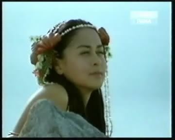 Marian Rivera smiling while looking afar in a scene from Dyesebel (2008 TV series)