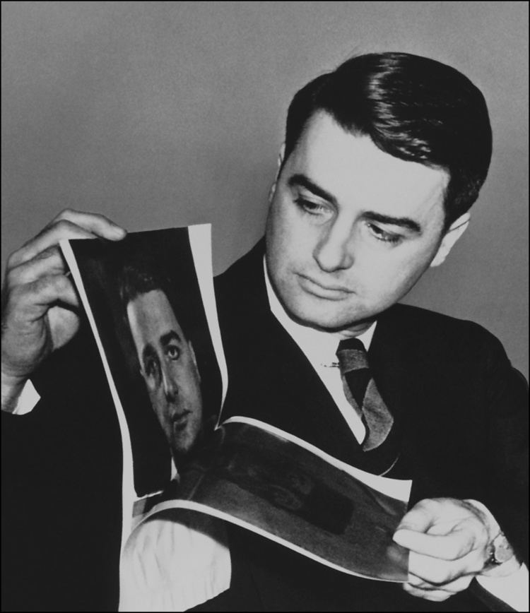 Edwin H. Land Edwin H Land inspects an oversized Polaroid image of