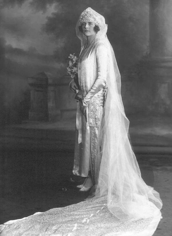 Edwina Mountbatten, Countess Mountbatten of Burma, holding a flower while wearing a wedding gown