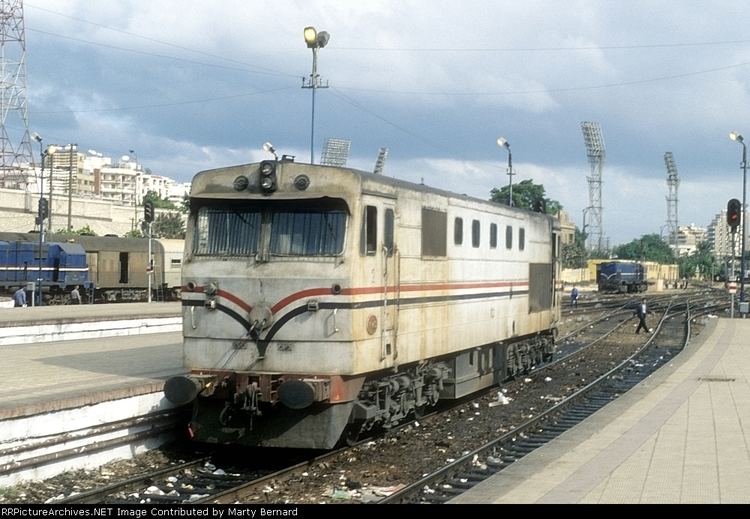 Egyptian National Railways, It has train railways, and a single old gray train wagon with other wagons parked at the station.