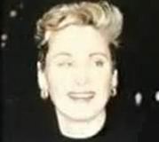 Elaine Parent smiling while wearing a black blouse and earrings