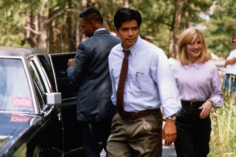 Esai Morales wearing white long sleeves, neck tie and brown pants with Crystal Bernard wearing pink long sleeves and pants