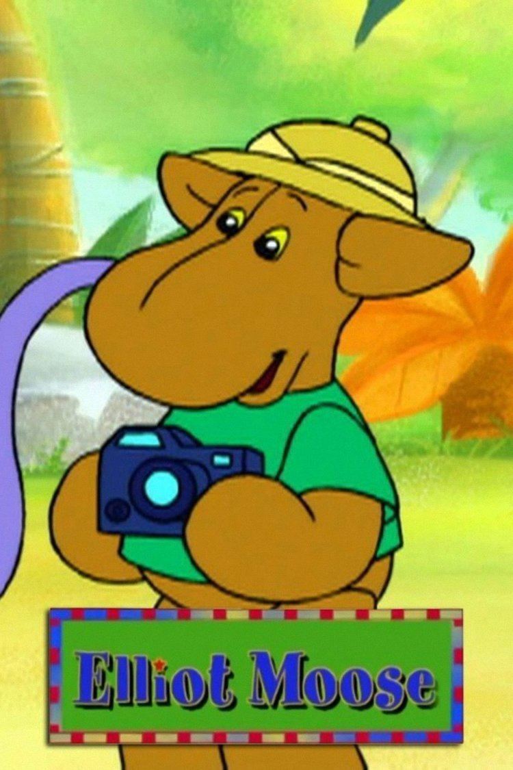 Elliot Moose from the TV series holding a camera with a brown skin tone and yellow eyes wearing a yellow hat and green shirt.