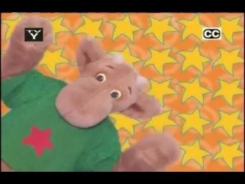 The costume of Elliot Moose is worn and has a green shirt with a red star in the middle having a yellow stars background.