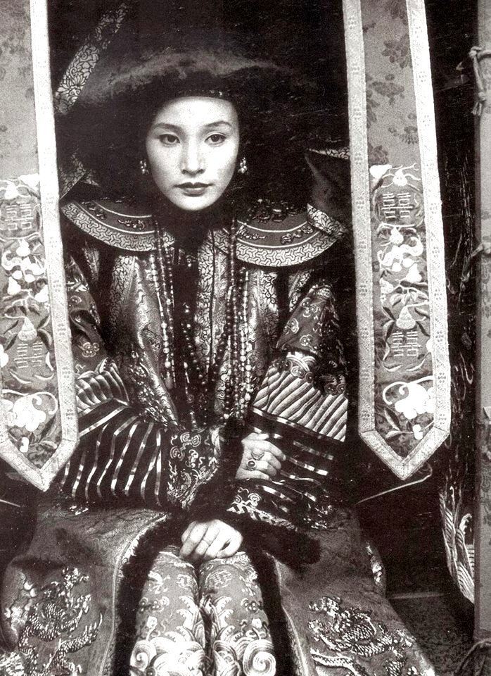 Actress Joan Cheng with a serious face plays the role of Wan Jung in The Last Emperor, a 1987 epic biographical drama film.