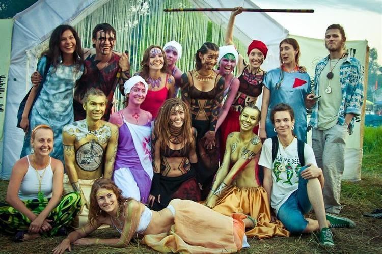 Participants smiling in different costumes and other participants wearing body paints during the Empty Hills Fest
