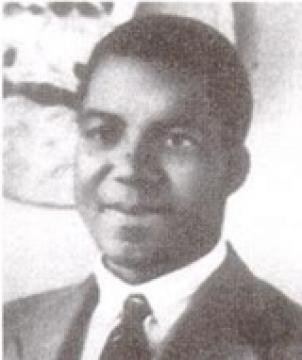 Young Engenas Lekganyane smiling while wearing a coat, long sleeves and necktie