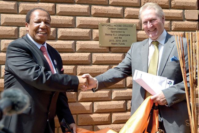 Engenas Lekganyane smiling while shaking hands with Andrew Cook at the official opening of the outdoor classroom at Mitchell House