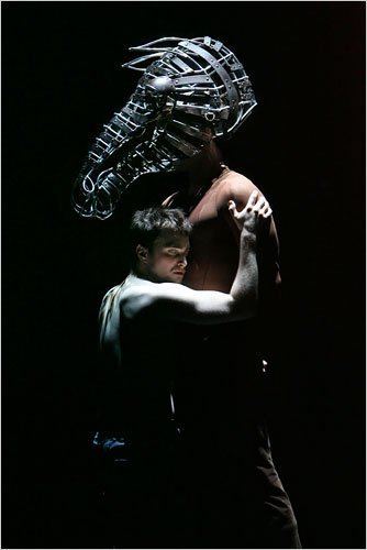 Daniel Radcliffe hugging the man playing the role of a horse with a wire cage around his head mimicking the shape and outline of a horse's head