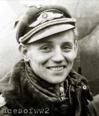 Erich Hartmann smiling while wearing a thick jacket and peaked cap