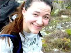 Esther Reed carrying her backpack wearing a gray shirt