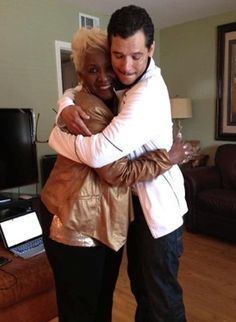 Etterlene DeBarge happily hugging her son Eldra Patrick "El" DeBarge inside their house and wearing a gold jacket.