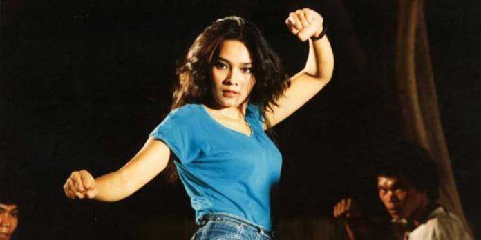 Eva Arnaz wearing a blue shirt on her action film