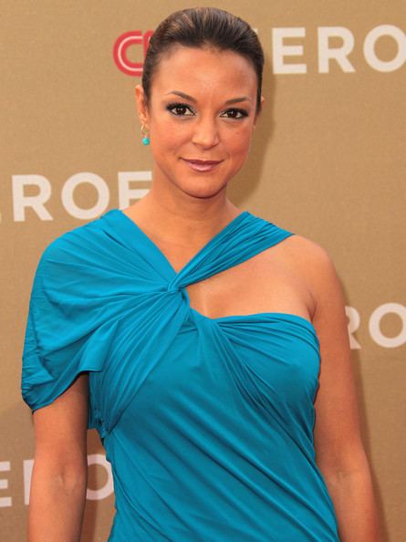 Eva LaRue is smiling, and has light brown hair, at the  CNN Heroes An AllStar Tribute, wears blue earrings, and a blue dress.