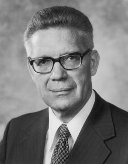 One of the members of the Church of Jesus Christ of Latter-day Saints wearing eyeglasses, a suit and a tie.