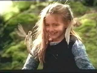 FairyTale: A True Story | A young girl (Elizabeth Earl) smiling in front of a fairy | movie scene