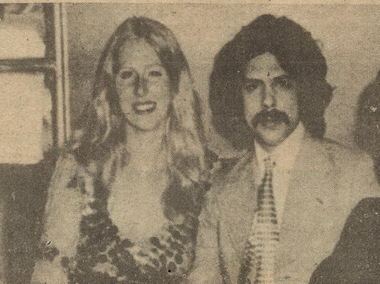 Faisal bin Musaid with long hair and a mustache, wearing a suit and a tie together with Christine Surma with a smiling face and long hair.